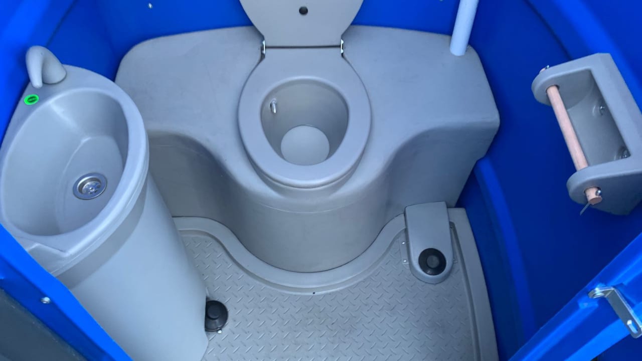 Portable toilet interior with toilet, basin, paper holder and foot controls
